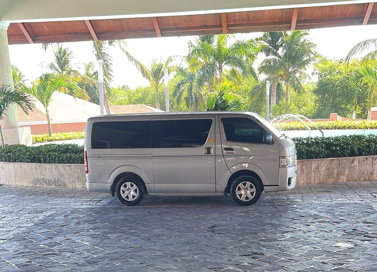 a van parked in a driveway with a car parked in front of it