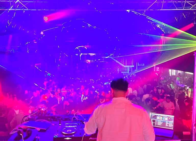 a dj spinning around in a nightclub