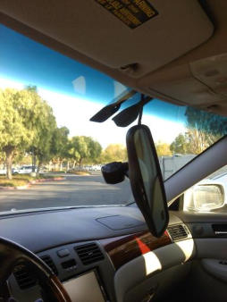 a car with a mirror and a mirror in the back ground