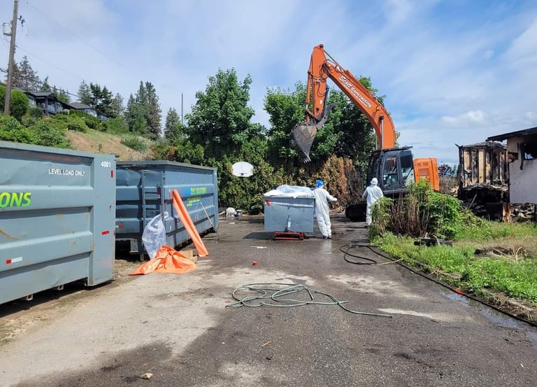 Excavator demolition of an asbestos containing structure