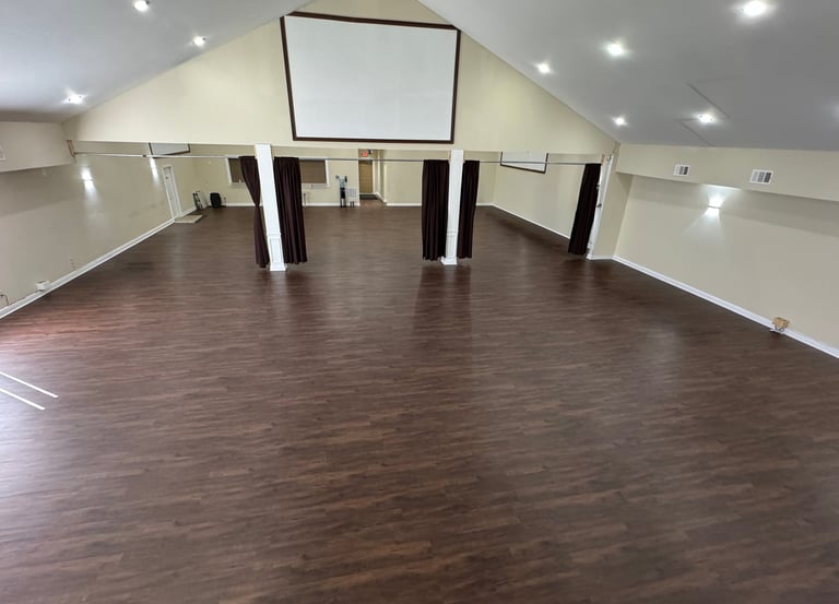 Empty open layout event space in Atlanta with hardwood floors