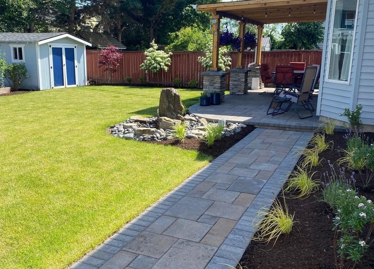 Beautifully maintained residential backyard with a stone walkway