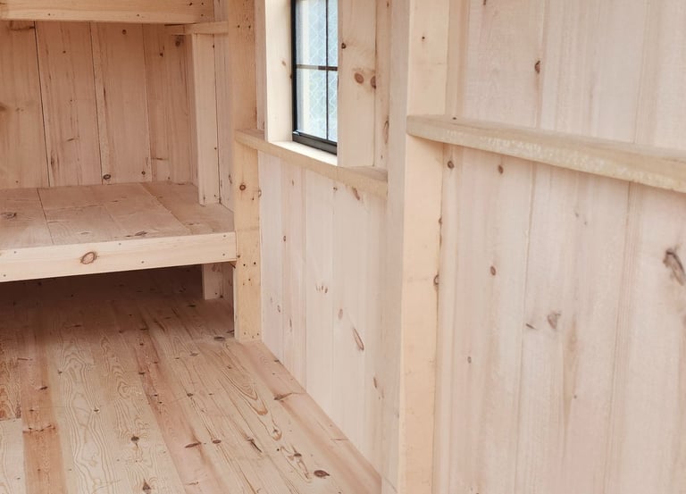 a room with wooden floors and a shelf with shelves