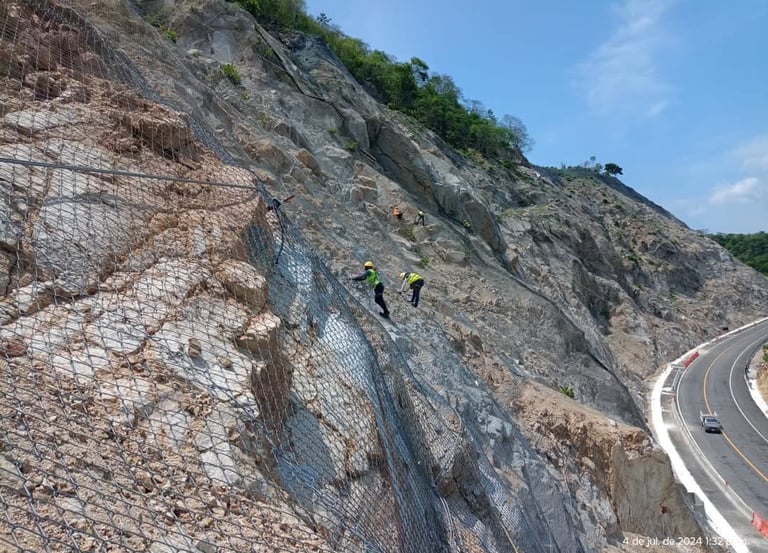 a group of people standing on a hill side road