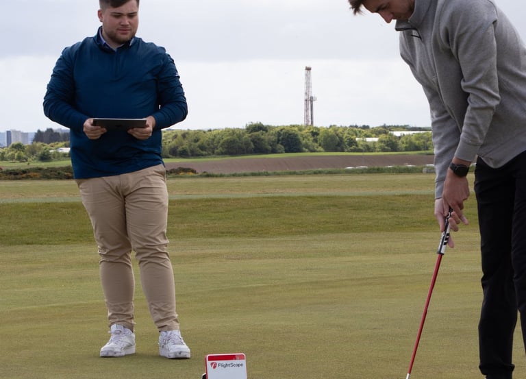 A golf coach in Aberdeen conducts a putting lesson using advanced technology and training aids to enhance putting skills