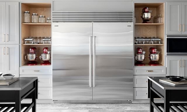 a kitchen with a refrigerator and a microwave