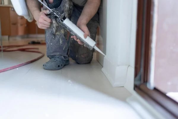 a man in a helmet is fixing a window