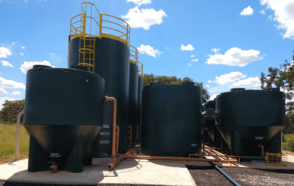 a large group of tanks with a yellow ladder