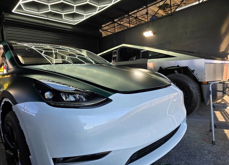 Dramatic color transformation: White Tesla receiving a high-quality green vinyl wrap at Bluemax Tint