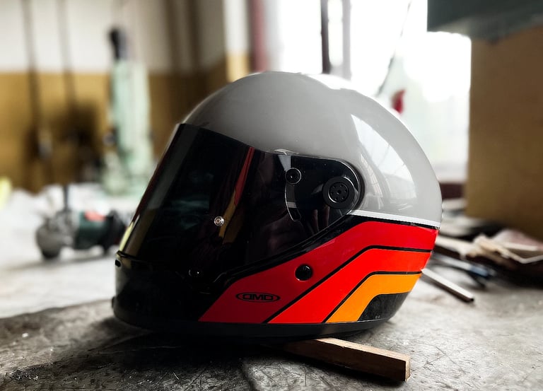 Kask DMD Rivale w kolorze Blade z przyciemnianą szybą na stole w garażu
