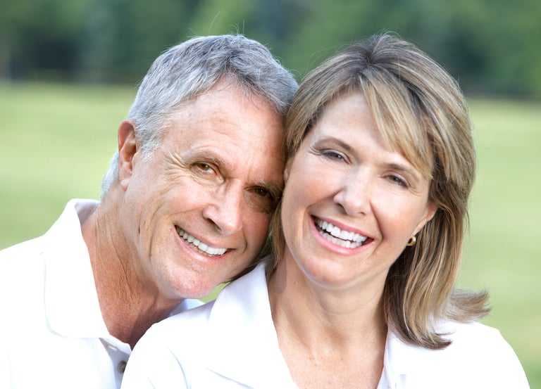 husband and wife smiling