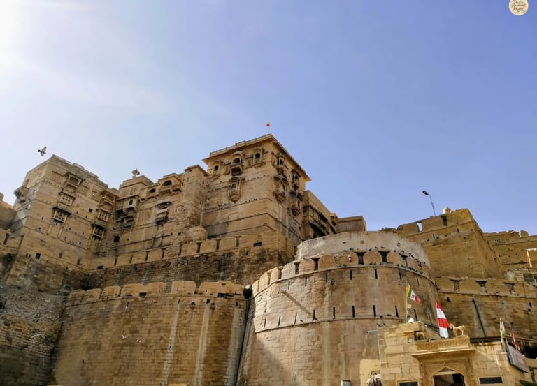 Jaisalmer Fort glowing in golden sandstone under bright sunlight.