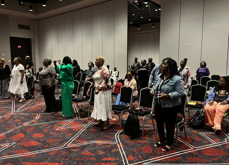 a group of Women leaders gathered in a room with chairs