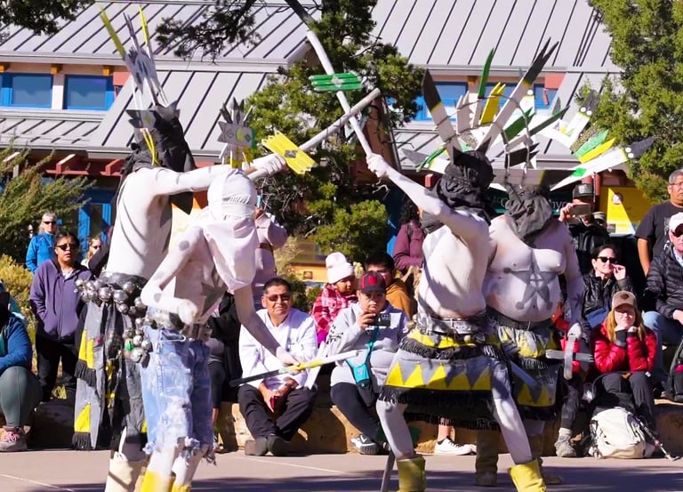 people in ceremonial costumes performing on at Grand Canyon National Park