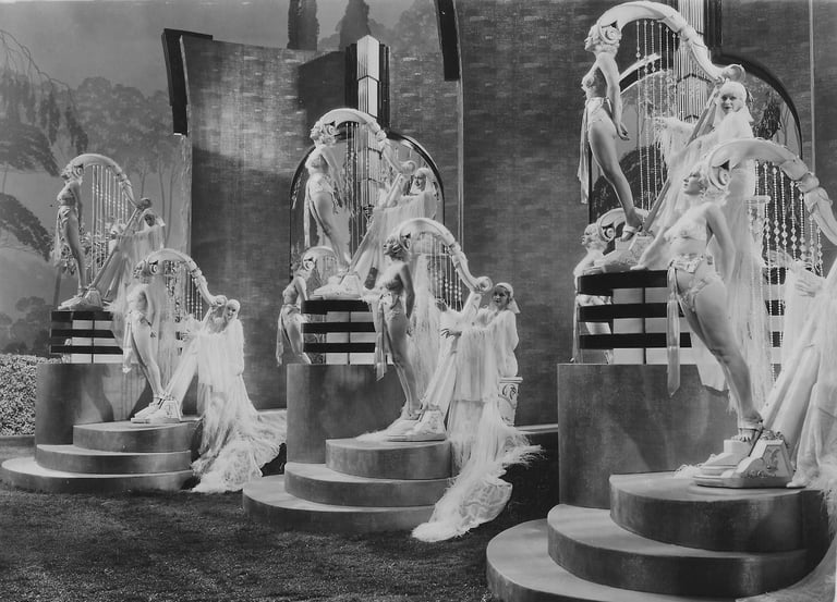 Three standing oversized harp props made of live women in a surreal Busby Berkeley musical number.