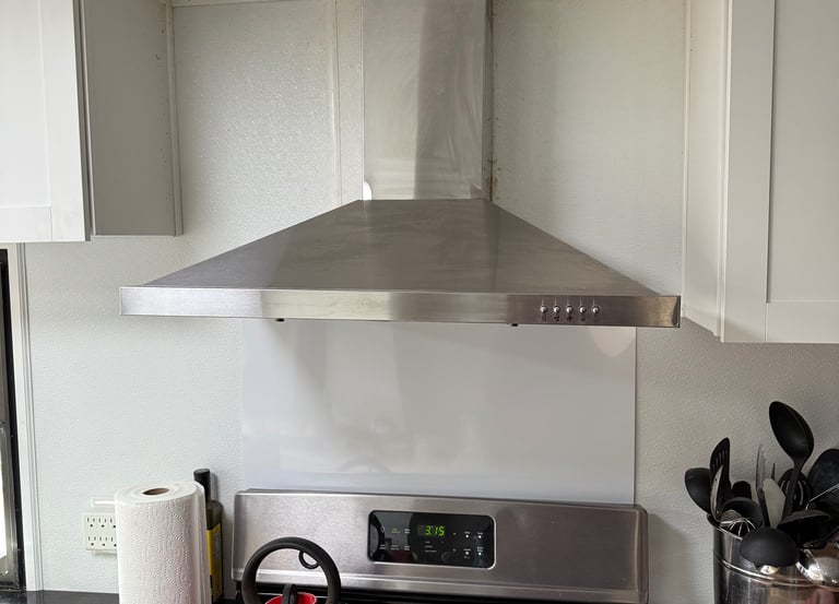 Modern kitchen with stainless steel range hood and stove – Cherry Home Service appliance installatio