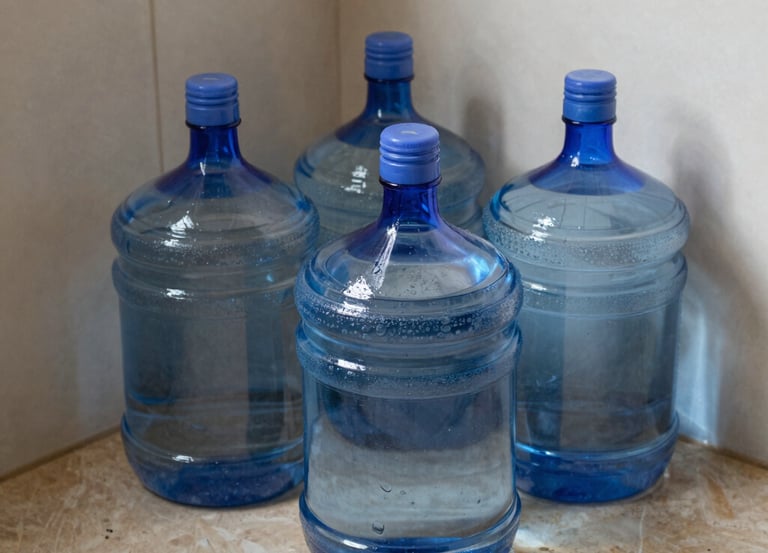 Office worker struggling with heavy water garrafas stacked in a cluttered storage room.