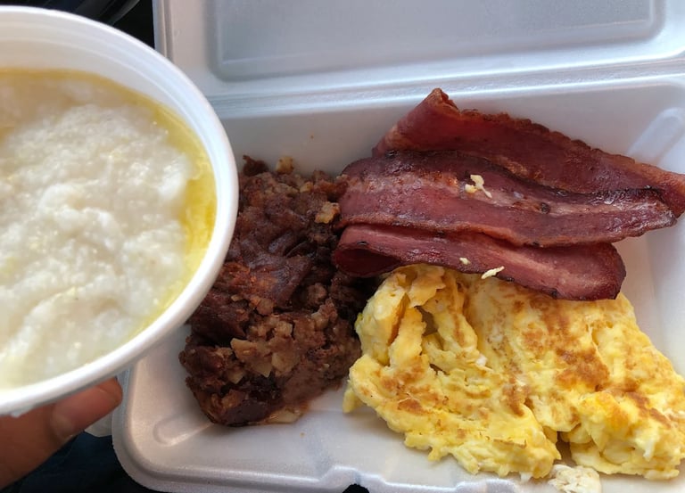 A sizzling breakfast platter with corned beef hash, eggs, and golden homefries at Charlie's Restaura