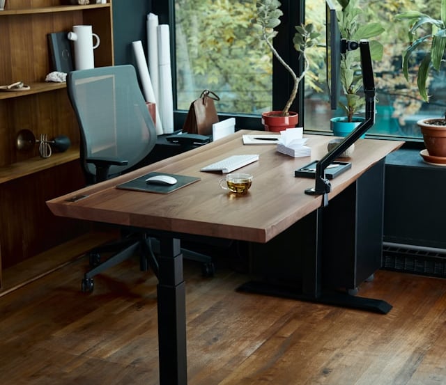 a desk with a laptop and a laptop on a wooden desk