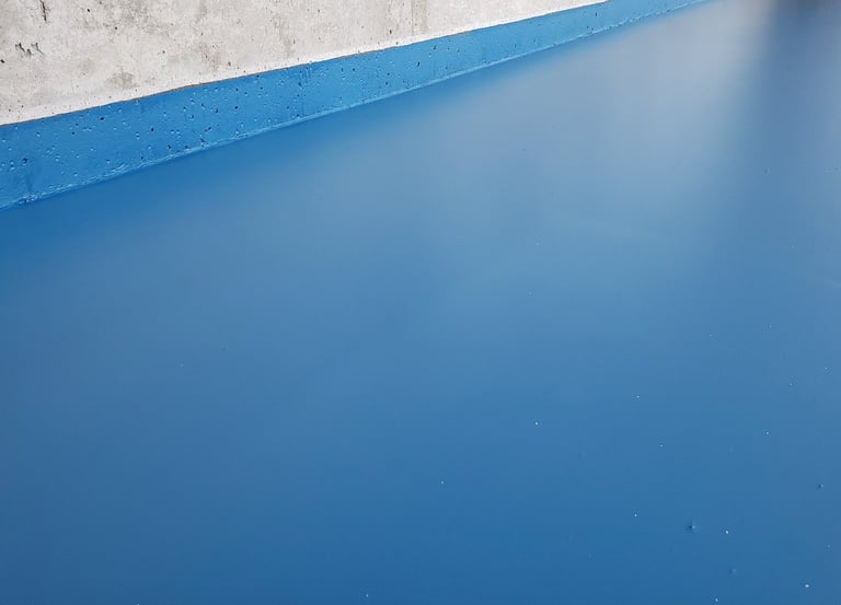 Blue epoxy garage floor with seamless residential finish