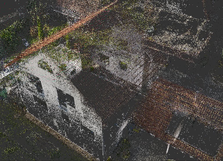 Aerial view of a high-resolution point cloud scan of a residential building and roof structure.