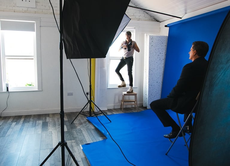 a man is taking a photo of himself in a studio
