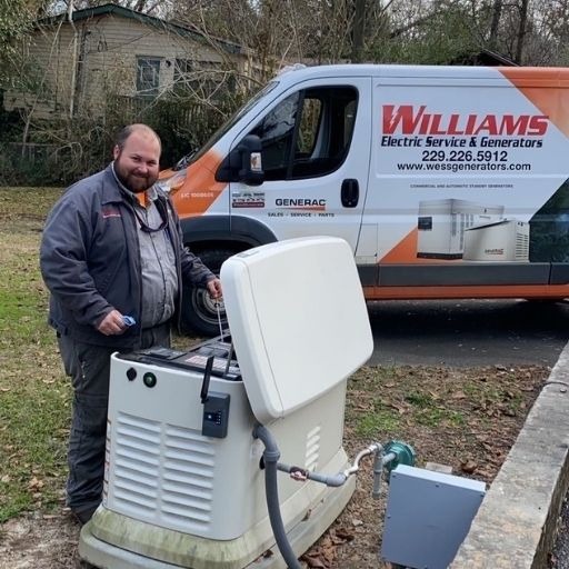 A Williams Electric Service & Generators van with a service tech standing over a Generac Generator