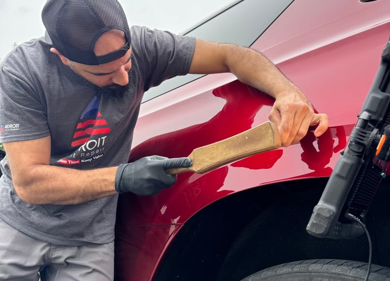 Mr. Sam knocking down a Tahoe to fix a ding