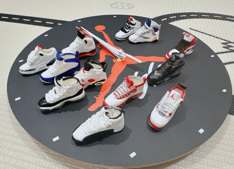 Miniature Air Jordan sneaker collection displayed on a round Jumpman clock face for home decor.
