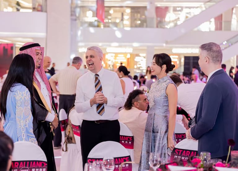 Diverse business professionals networking and laughing at a formal Star Alliance corporate gala event.