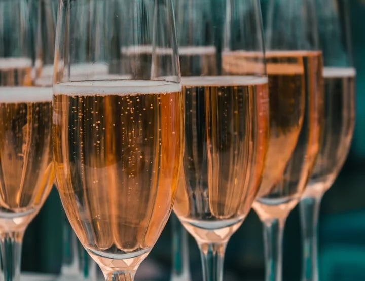 a row of wine glasses sitting on top of a table