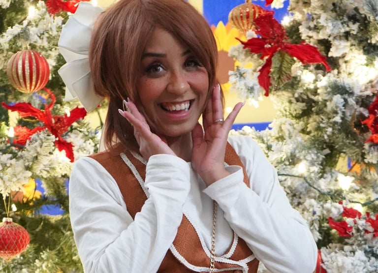 Gingerbread elf smiling for a photo