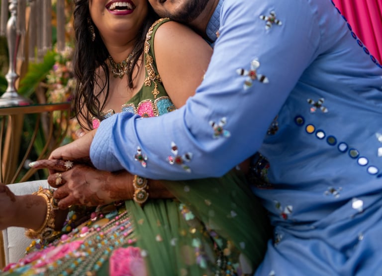 a man and woman in a colorful dress and a man in a blue suit