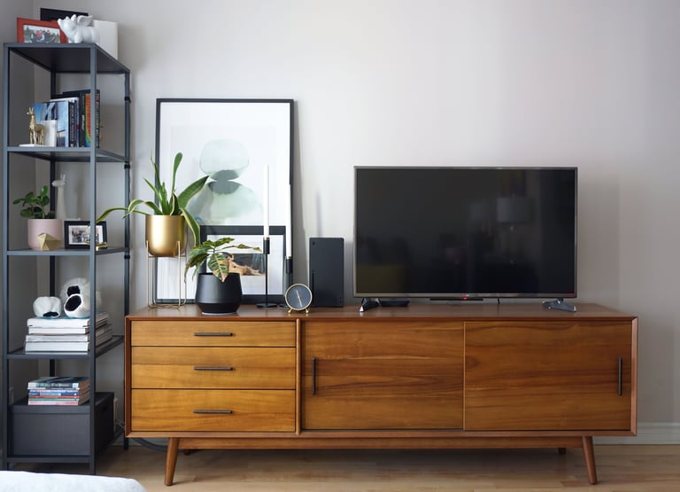 A mid-century modern vanity with TV and stylish décor.