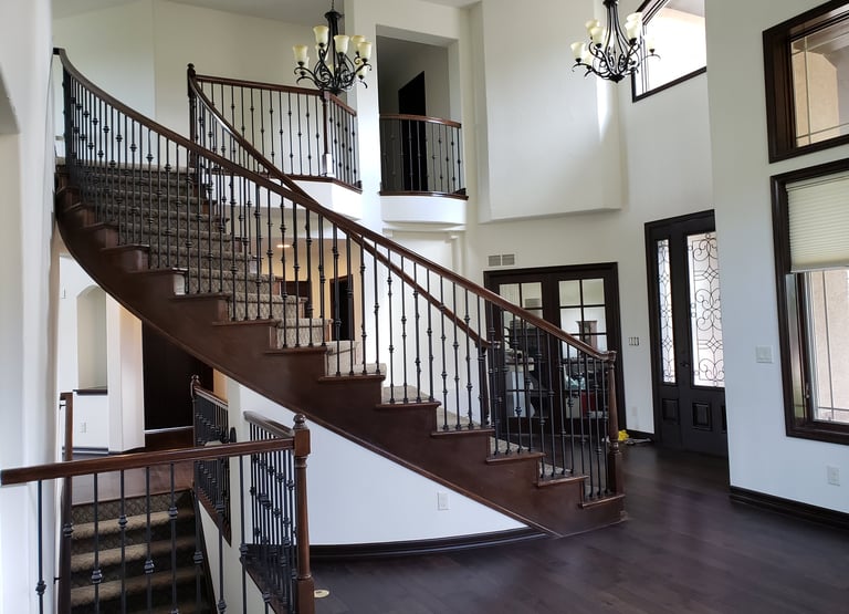 a staircase leading to a second story balcony