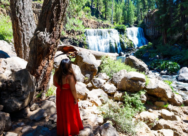 california, waterfalls, mccloud falls, a woman in a red dress standing in front of a waterfall