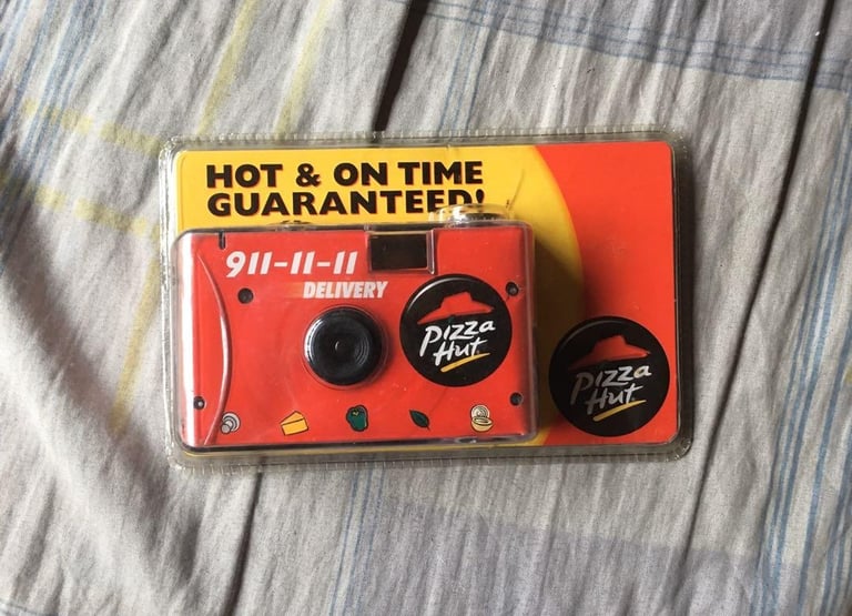 A packaged disposable film camera, in Pizza Hut's iconic colors and logo.