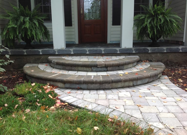 Leppek Landscapes designed and installed landscape paver walk way and porch. 