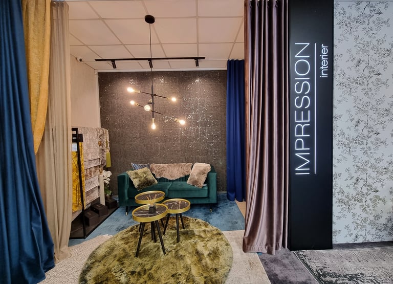 Modern living room showroom display with velvet sofa, designer lighting, and luxury curtains.