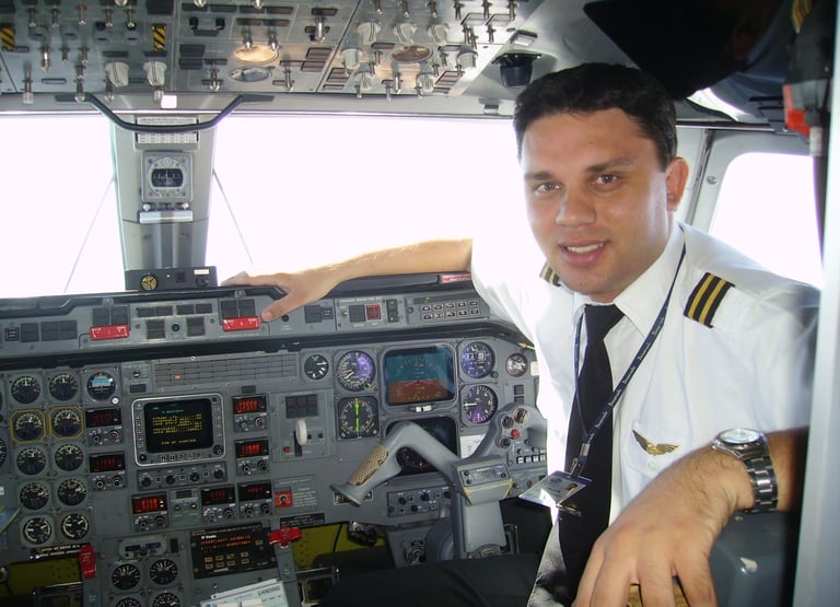 a man in uniform is sitting in a plane emb120 flightdeck