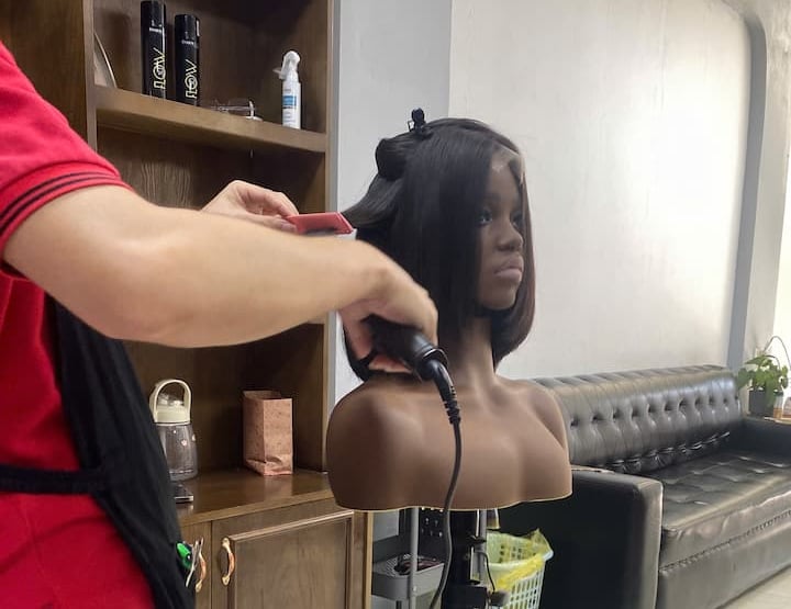 Stylist finishing a Vietnamese human hair bob wig at Vietsilkhair.