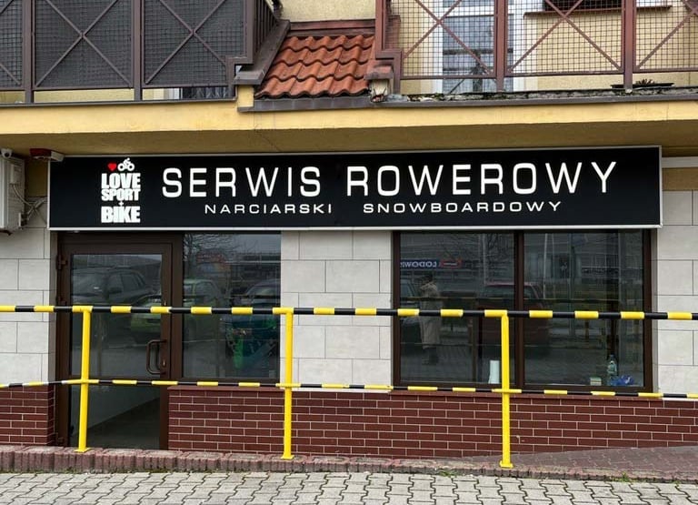 a service bike and snowboard skis center with a sign that says service overcrowing