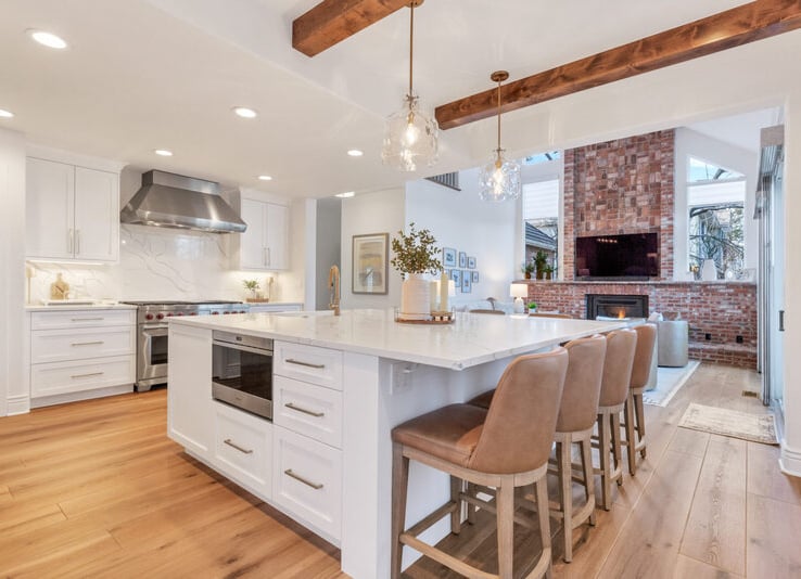 a kitchen with a large island and a fireplace