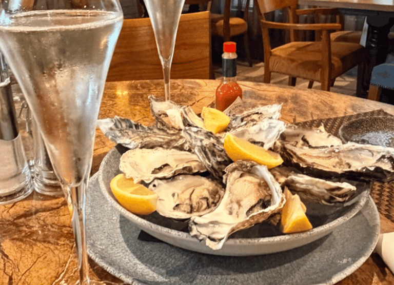 Glasses of champagne and a plate of oysters