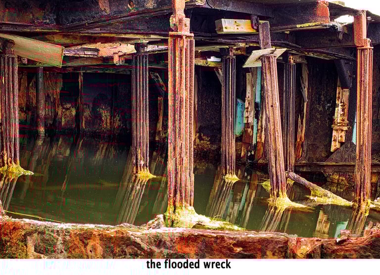 the inside of a flooded wrecked metal boat
