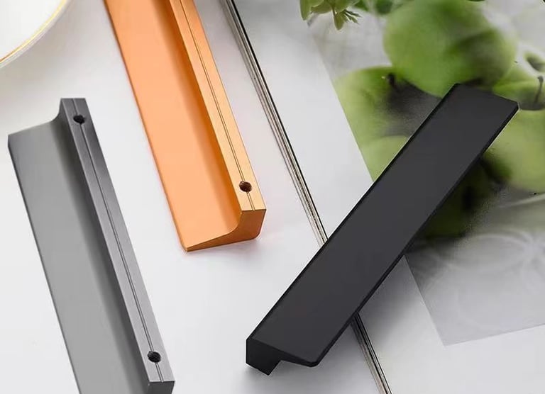 Set of modern cabinet door handles in black, gray, and copper metallic finishes for kitchen or furniture hardware