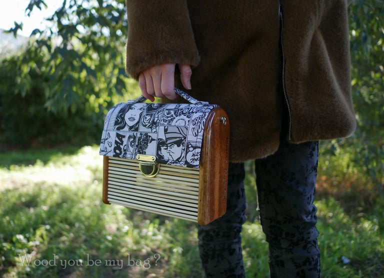 a woman in a coat holding wooden bag made from mahogany wood, bamboo sticks and comic fabric
