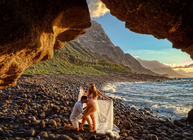 a man and woman standing on a rocky beach