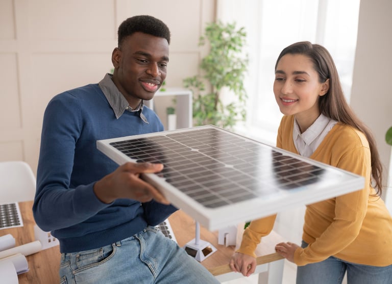 a man and woman holding a solar paneled solar panel