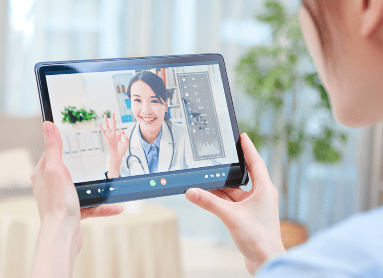 a woman in a doctor's office is holding a tablet computer